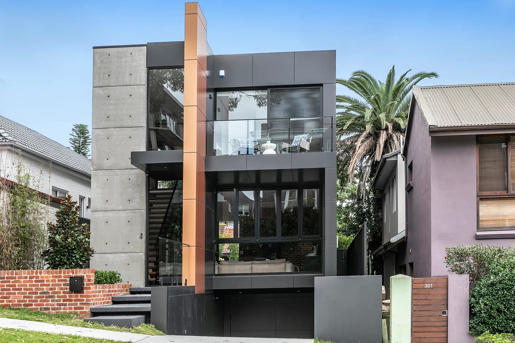 Street elevation of The Arc, a three-storey off-form concrete and glass home in Bondi Beach built by Merc.Build