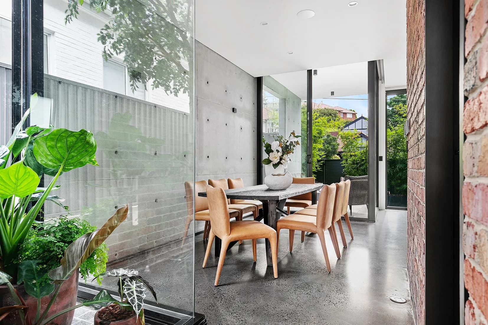 Double-height garden atrium at The Arc bringing greenery into the dining and living spaces