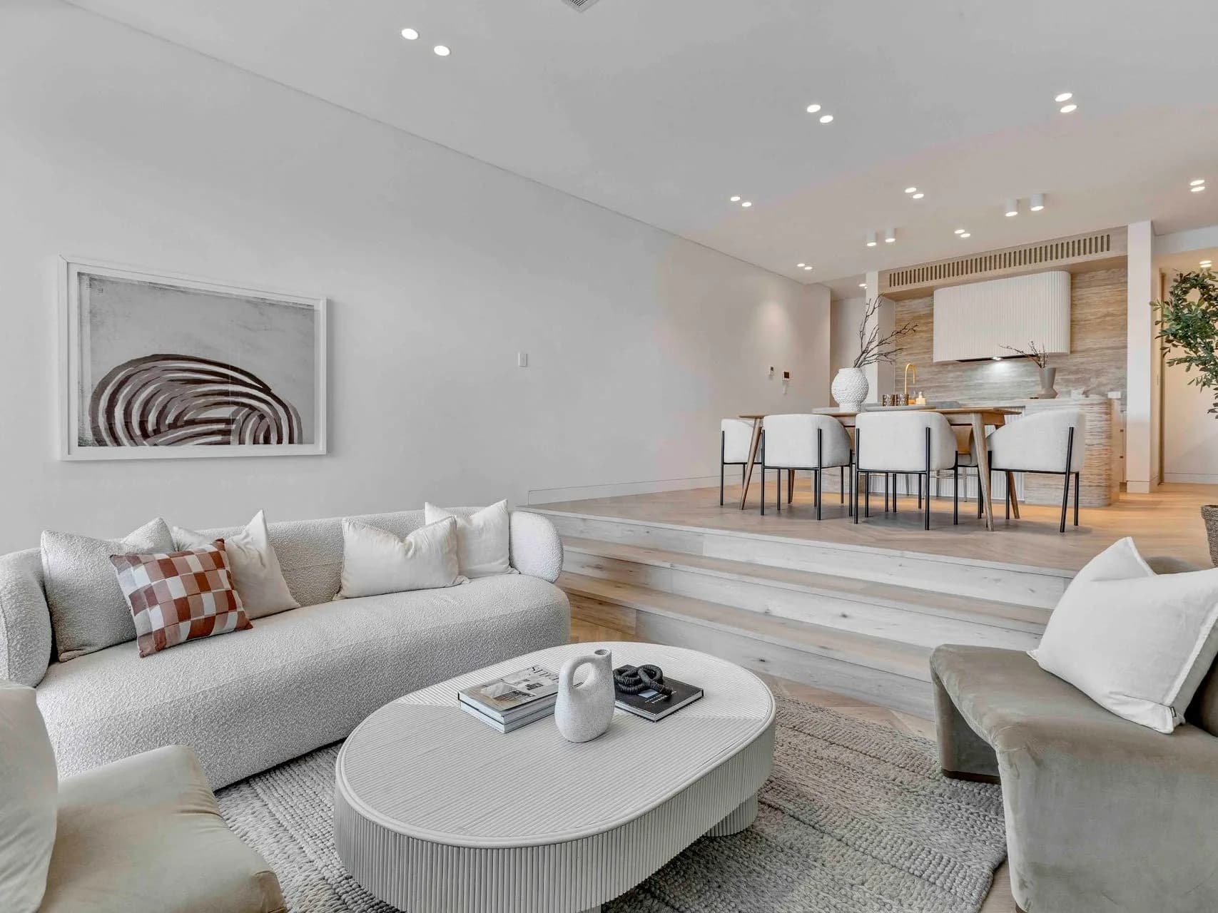 Open-plan living and dining at Hillary flowing to the garden through full-height glazing