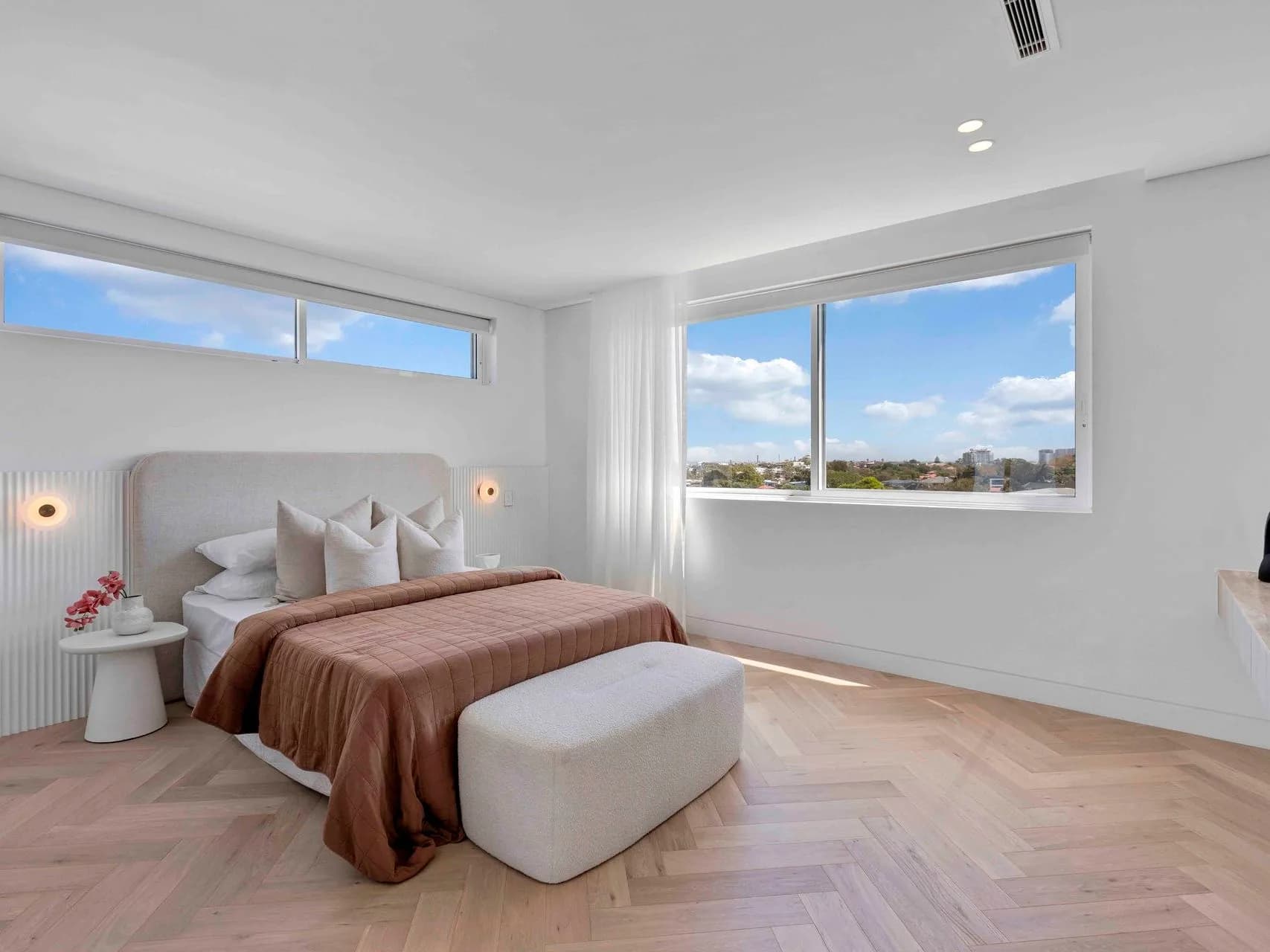 Master bedroom at Hillary with herringbone oak floors and district views over Matraville