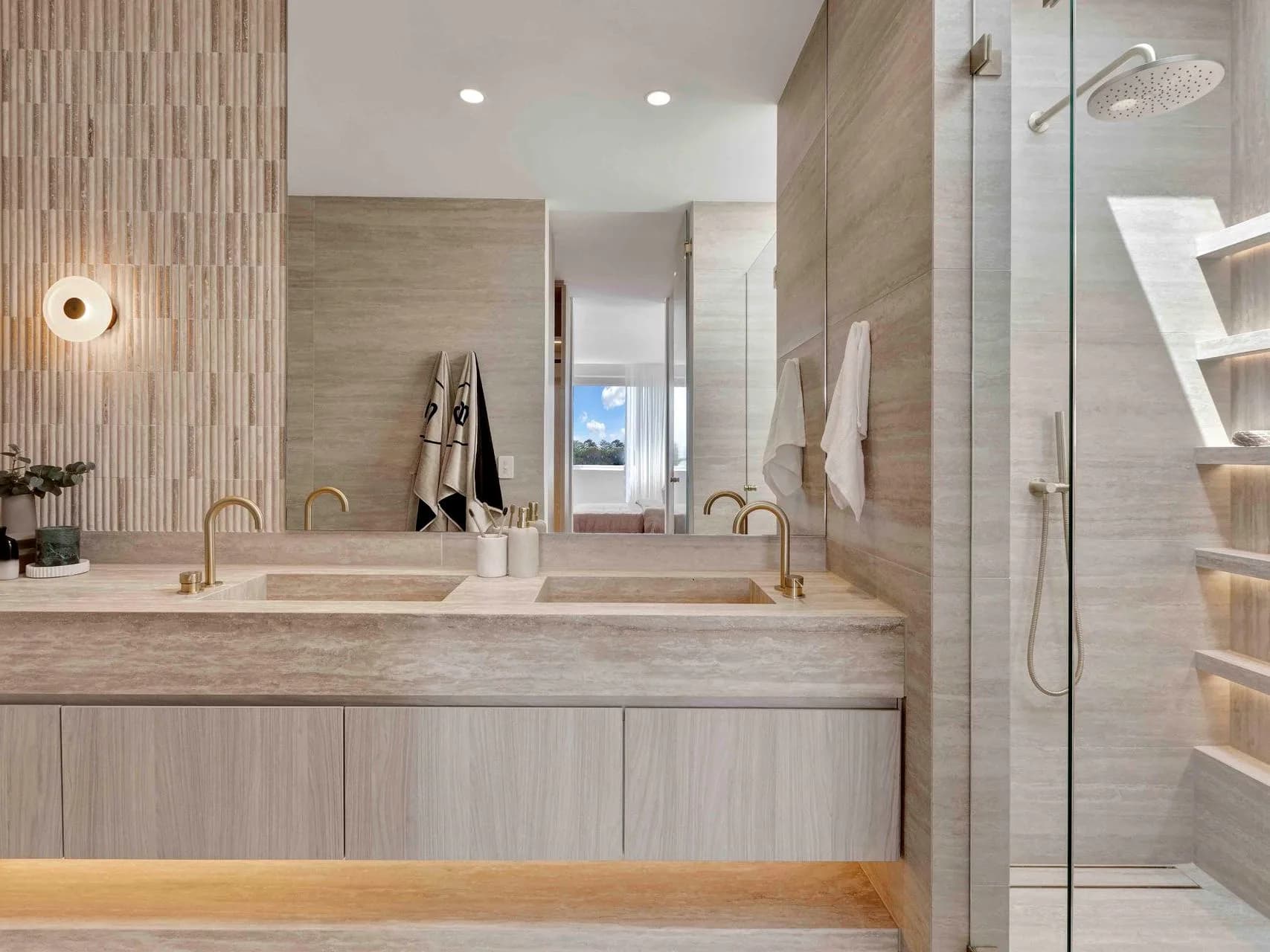Ensuite at Hillary with a marble double vanity, microcement walls and Parisi fittings